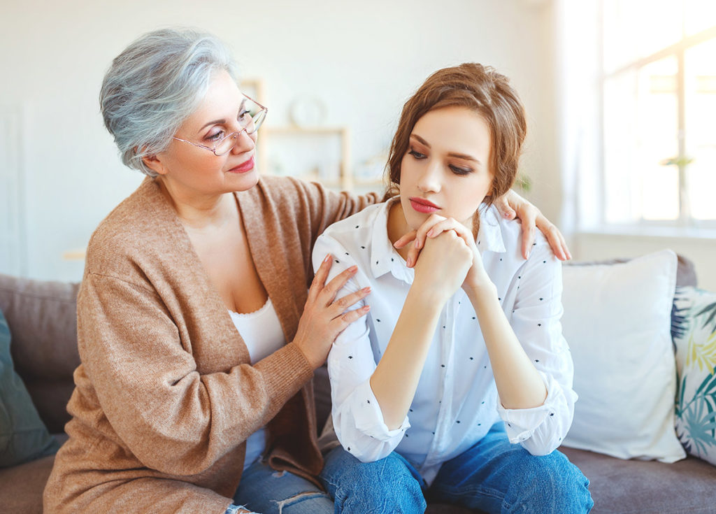 mother with arms around daughter after learning How to Help an Addict