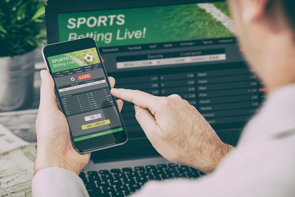 a person with a problem with gambling uses a sports betting app on their computer and phone