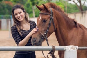 a person pets a horse during equine therapy for eating disorders