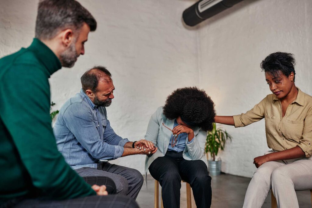 Person surrounded by loved ones during an eating disorder intervention