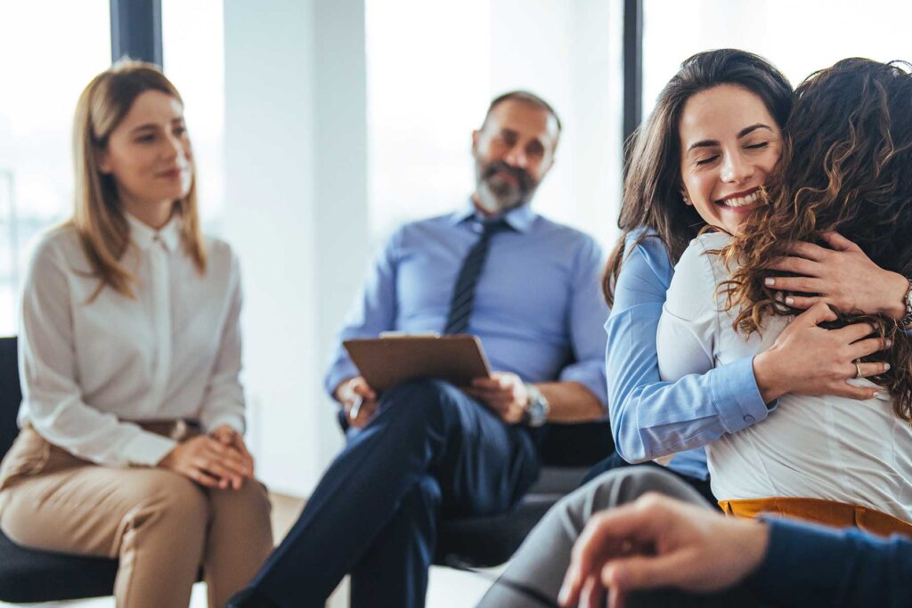 Group of people in therapy helping each other gain confidence in recovery