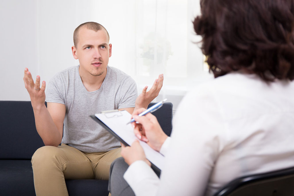 man on couch talking with therapist dual diagnosis and drug detox