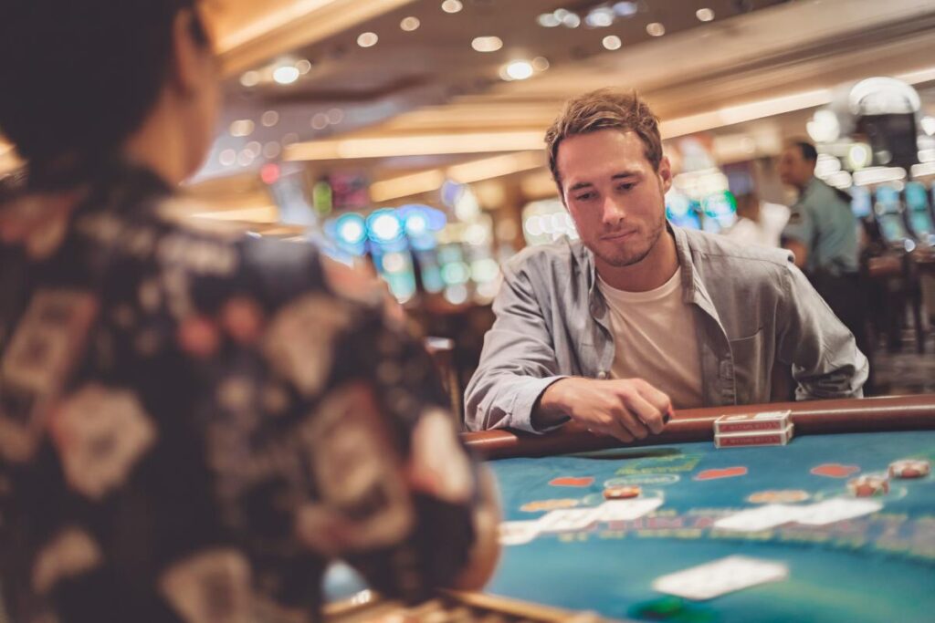 Man sitting at casino game table after gambling becomes addiction