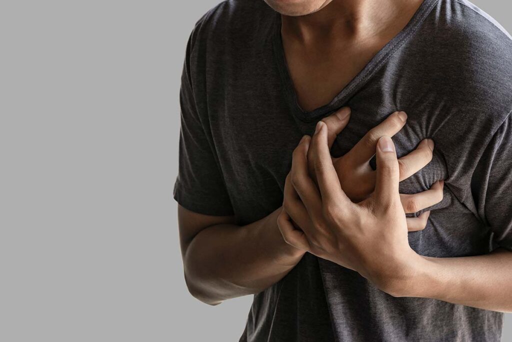 a person cluethces their chest which may be a sign of prolonged adderall abuse