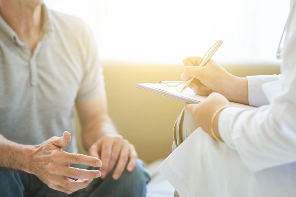 a doctor talks to a patient about alcohol and hemochromatosis