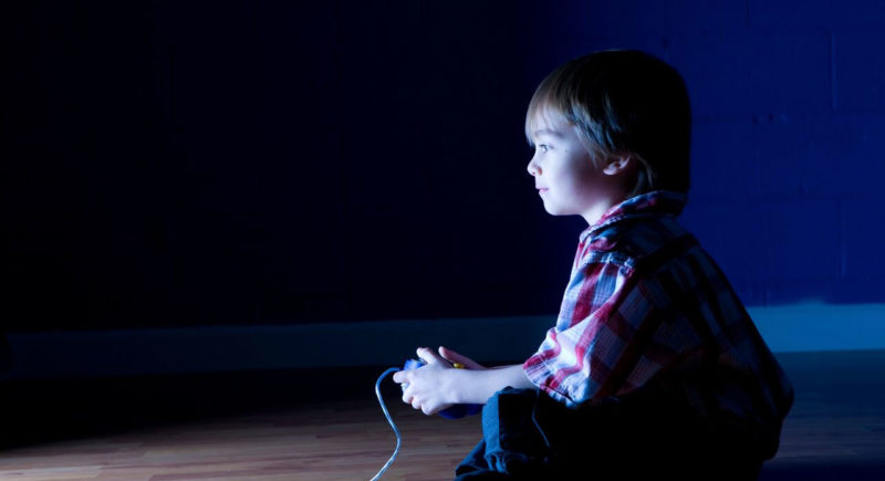 Child in front of television playing video games