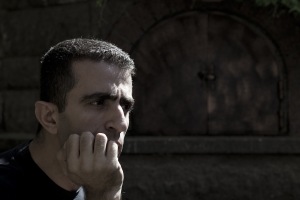 man resting on his hand looking into the distance