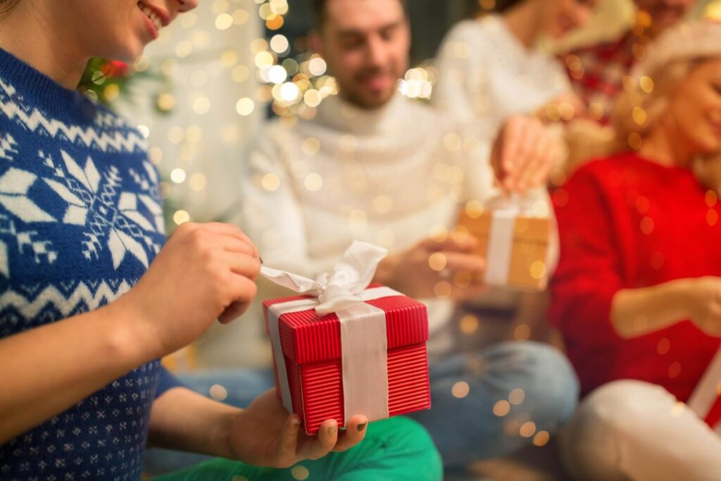 people unwrap gifts during a sober holiday celebration