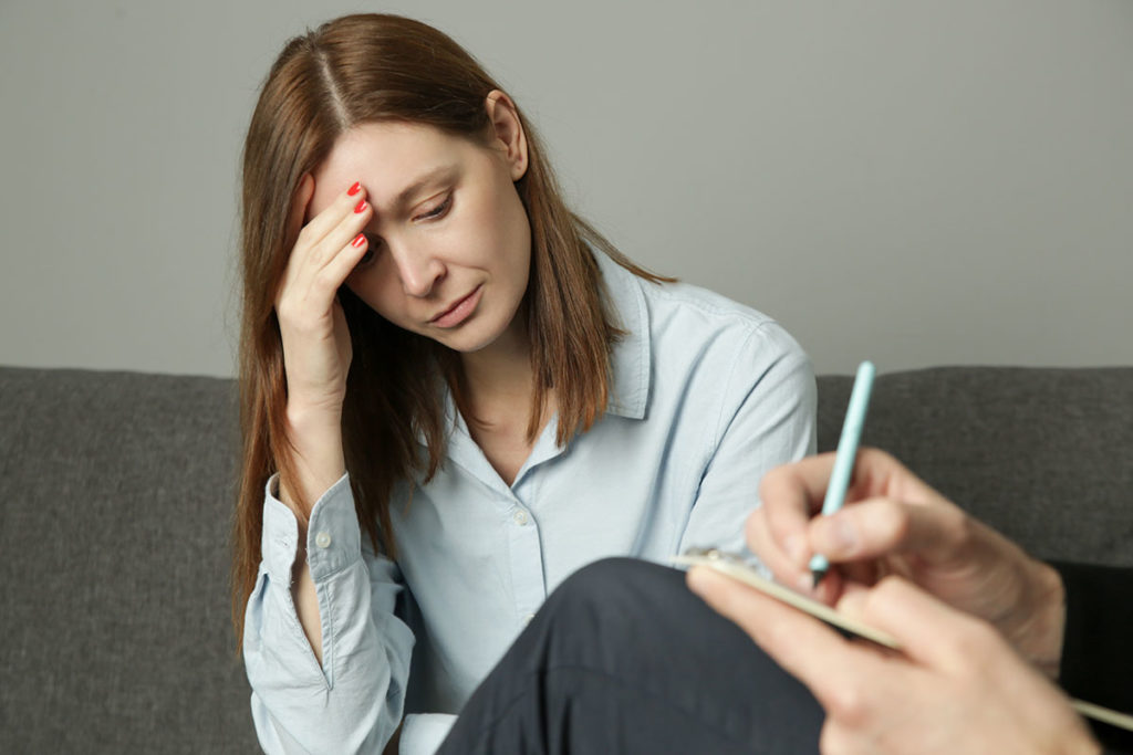 woman thinking about what hinders your recovery