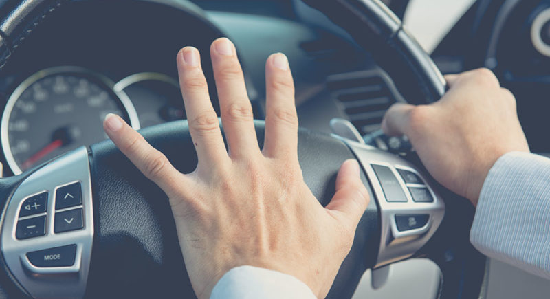 man in car honking horn