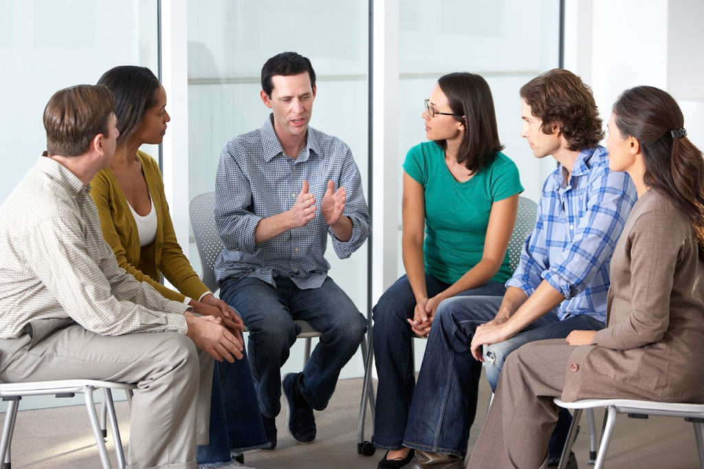 man speaking to support group