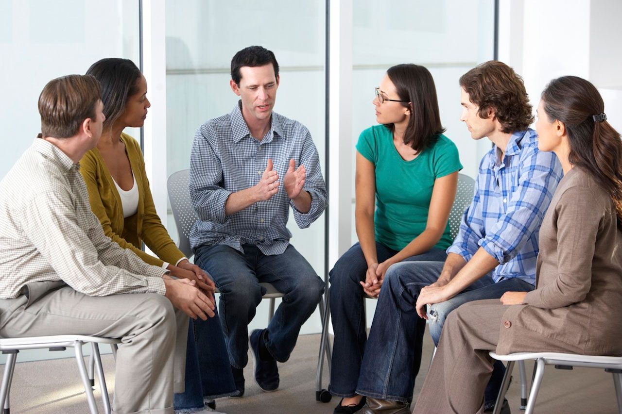 man speaking to support group
