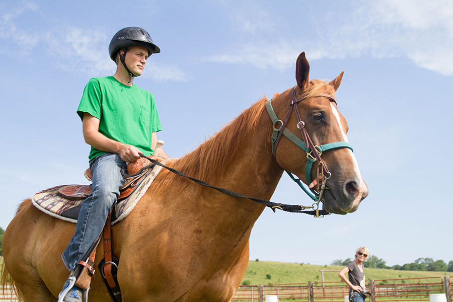 man riding a horse at The Ranch