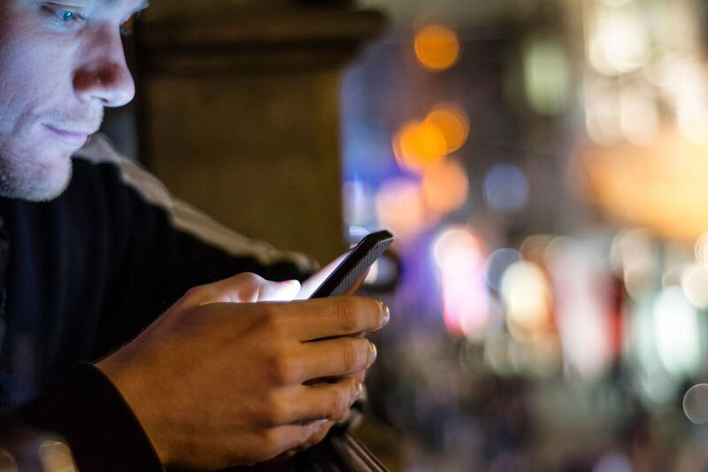 man looking at smart phone