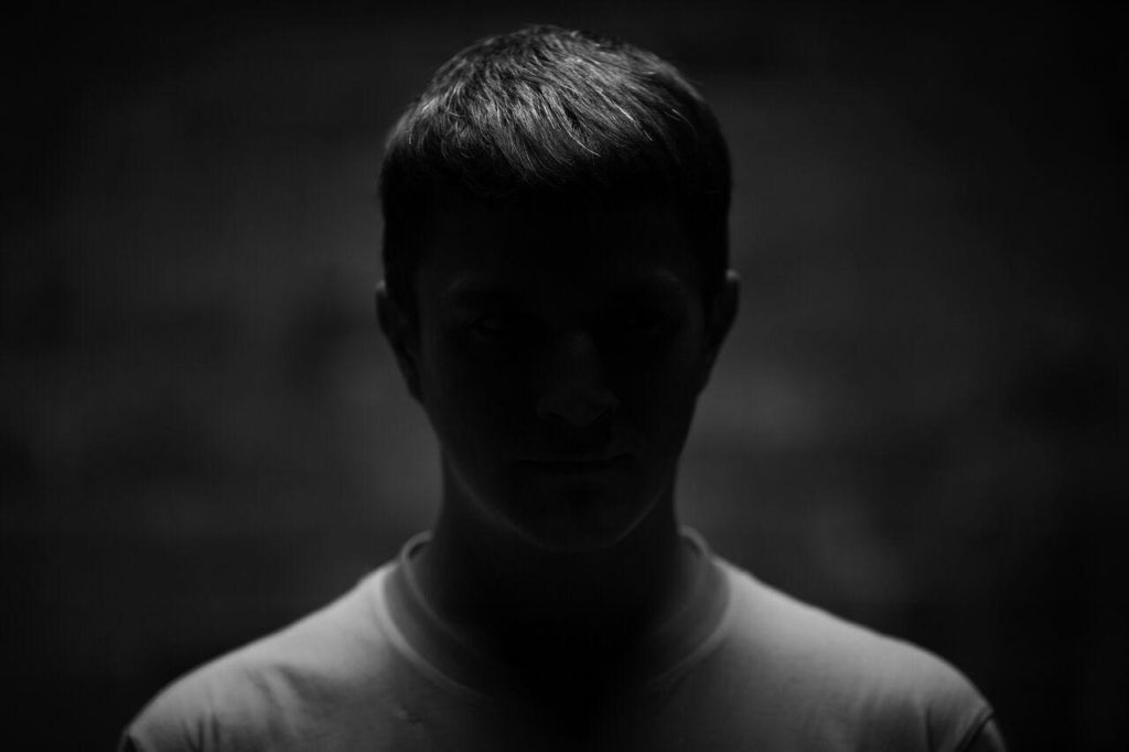 young man in the dark