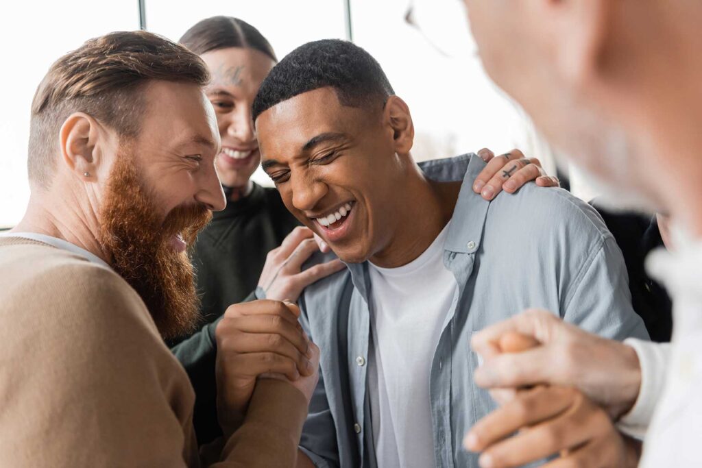 Man surrounded by supportive group in a refuge treatment center