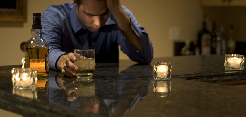 man struggling with drink