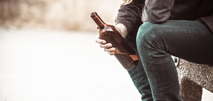 holding a wine bottle