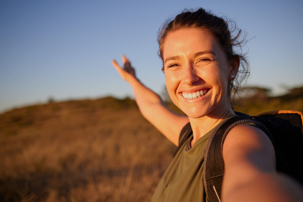 Happy woman participating in adventure therapies for addiction recovery