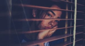 woman looks out the window at a bipolar disorder treatment center