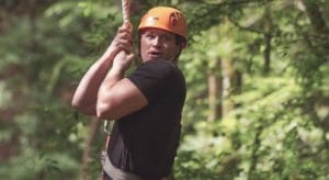 Man enjoying the ranches ropes course part of adventure therapy programs