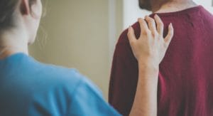 man works with therapist at a residential PTSD treatment center