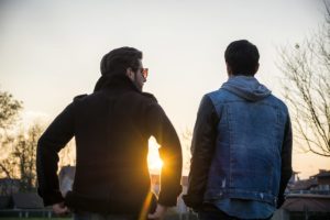 men in jackets talk outside an alcohol addiction treatment center