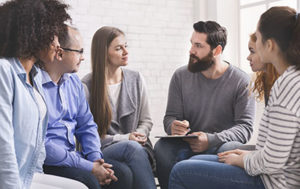 men and women at a 12 step therapy program overcoming their drug addictions