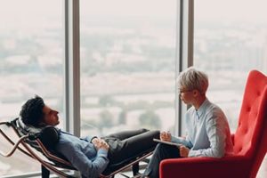 a doctor listening to a patient talk about his time at a experiential therapy program