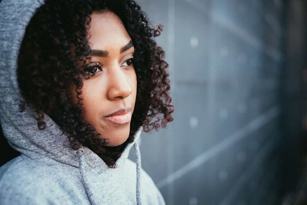 a woman staring off thinking about opioid epidemic statistics