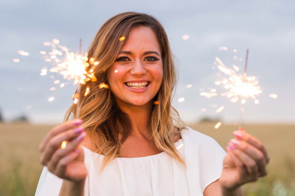 a person holds sparklers to celebrate a sober new year