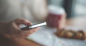 a person looking up process addiction treatment on their phone