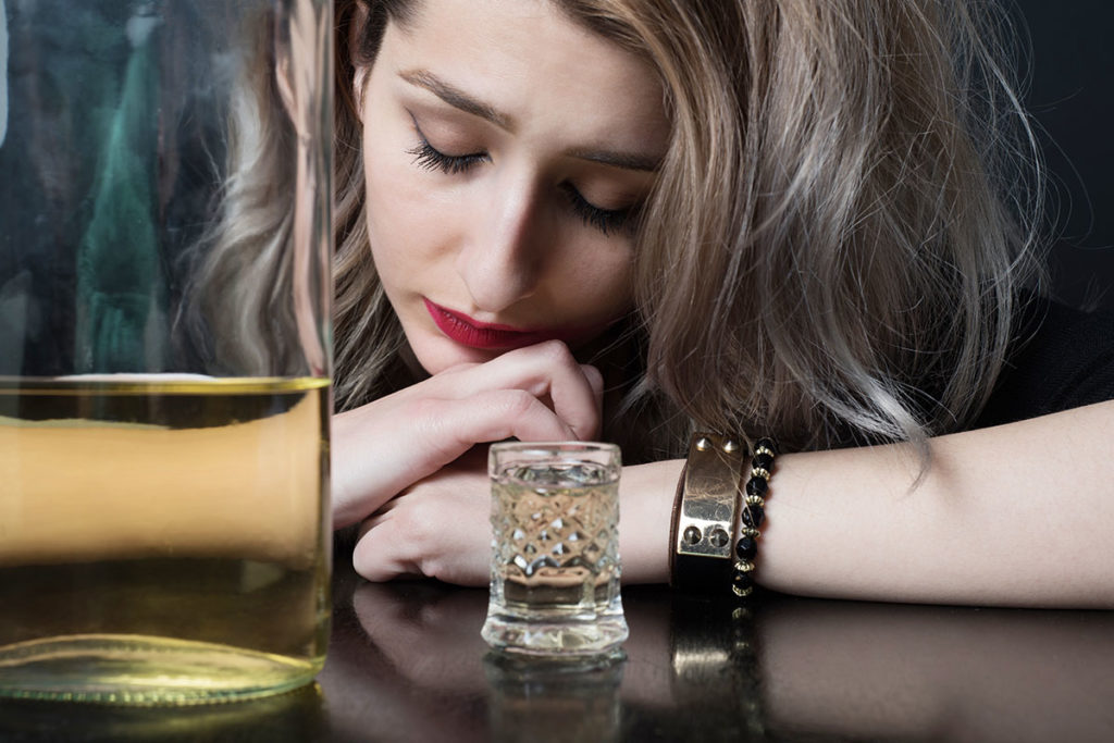 a woman suffering from PTSD and alcohol dependence