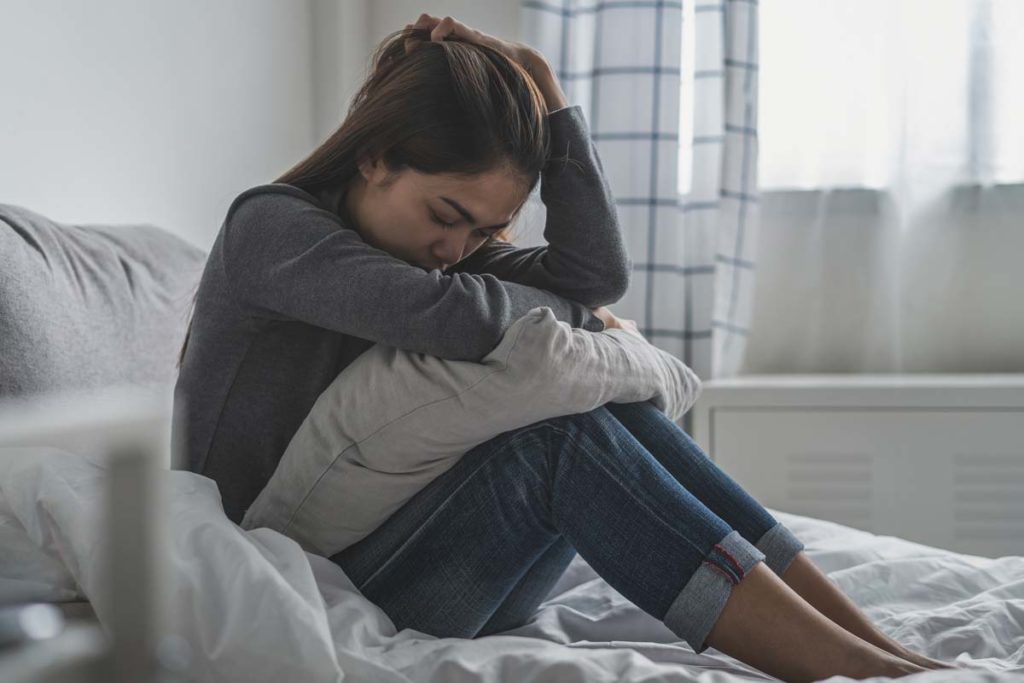 woman thinking about commonly abused prescription drugs