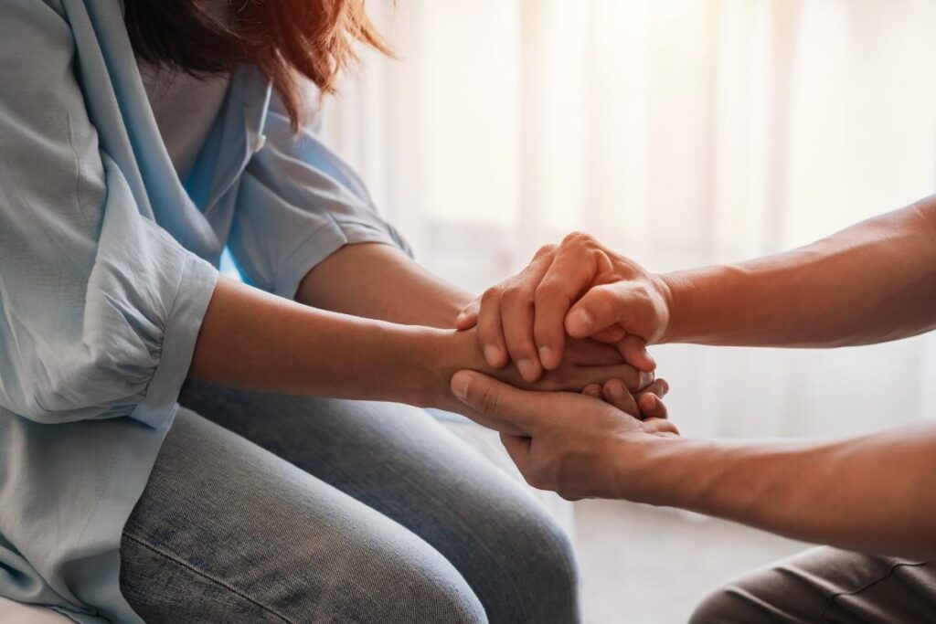 two people hold hands, possibly struggling with a love addiction