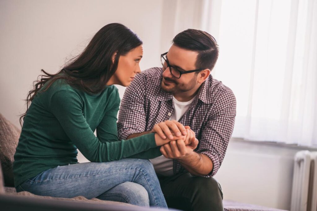 a couple holds hands possibly talking about the link between sex and depression