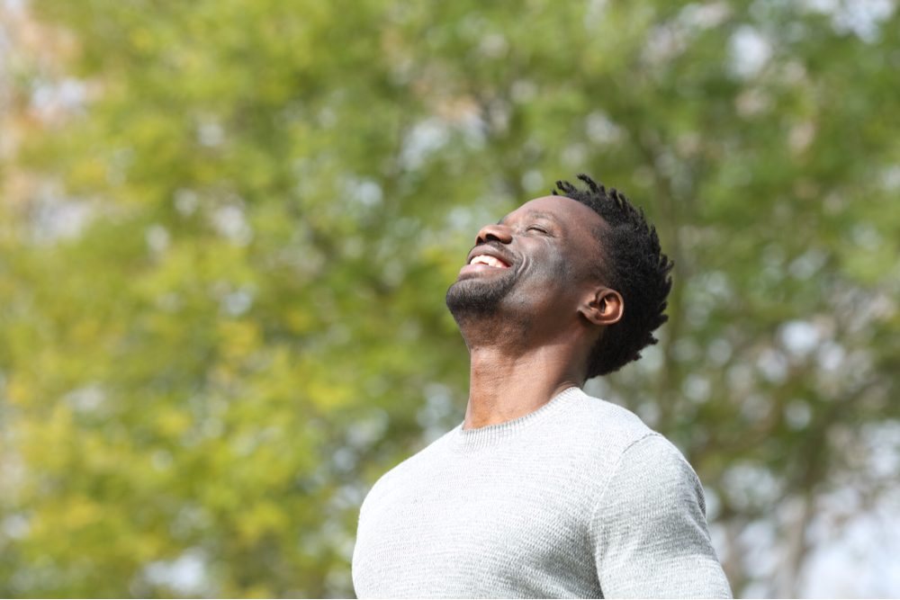 Happy man outside practicing soul exercises
