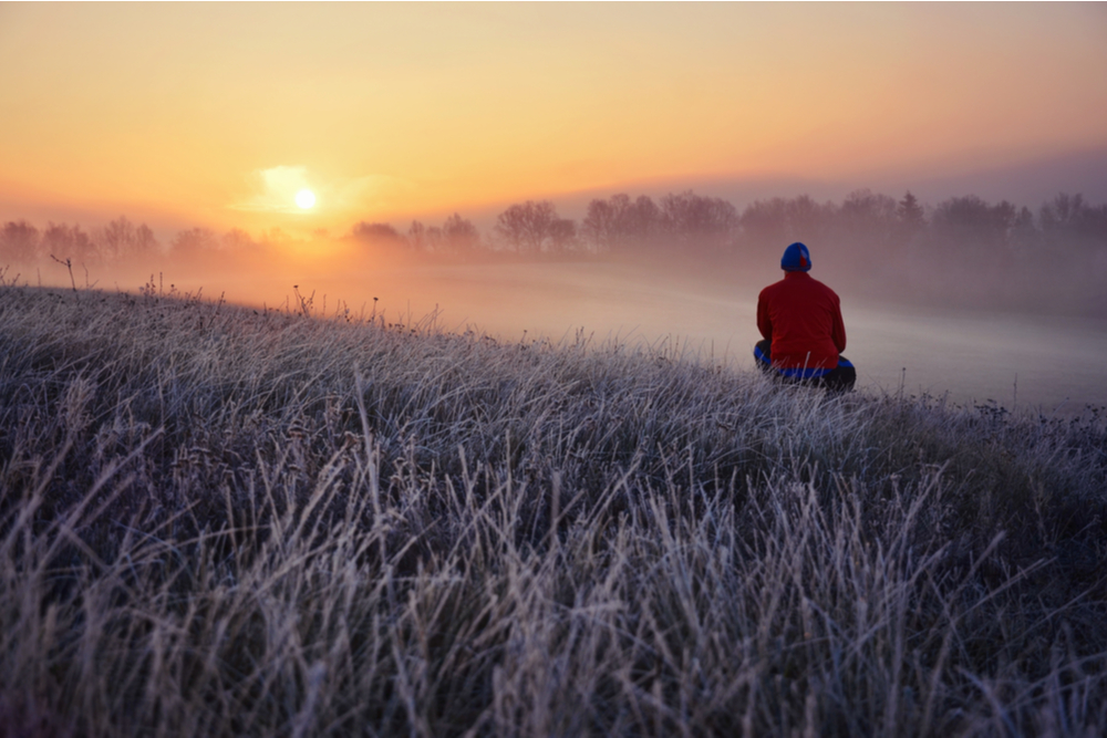 Man watching sunrise getting treatment during the holidays