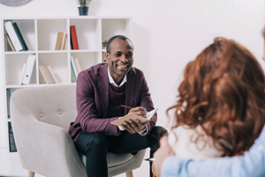 a person talks to a therapist and smiles in a dialectical behavior therapy program