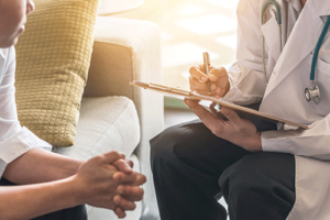 Close-up of therapist and client talking about indian health services rehab insurance coverage