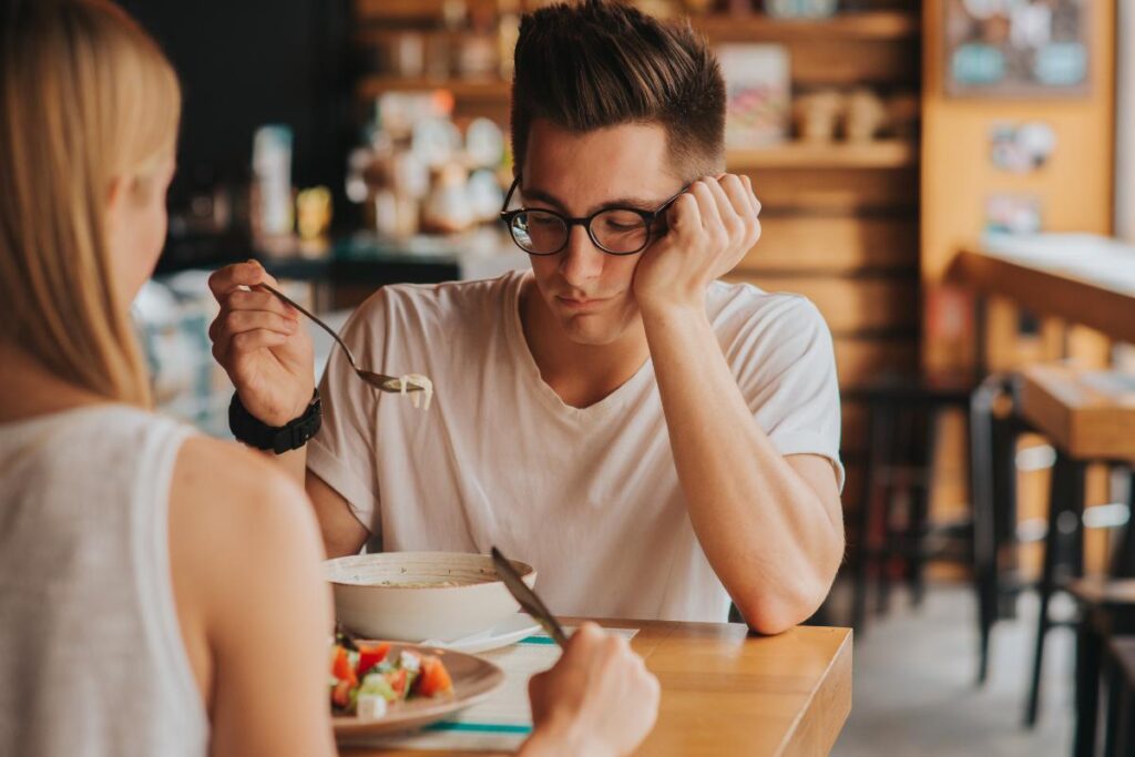 A man wondering, "What is the link between alcohol and eating disorders?"