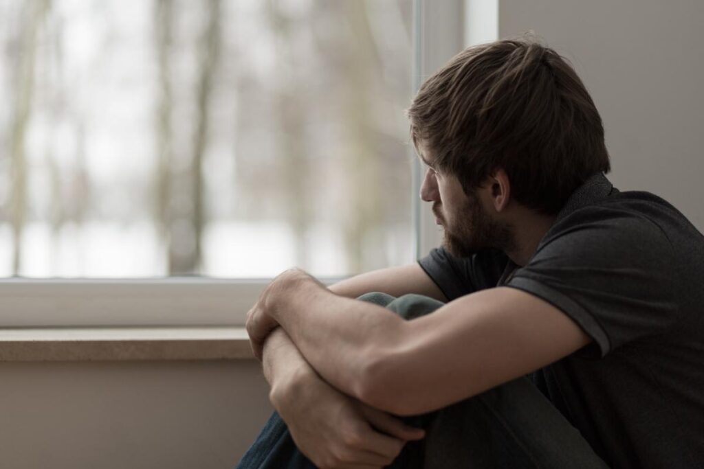 person looking out window wondering what is meloxicam and if it can help