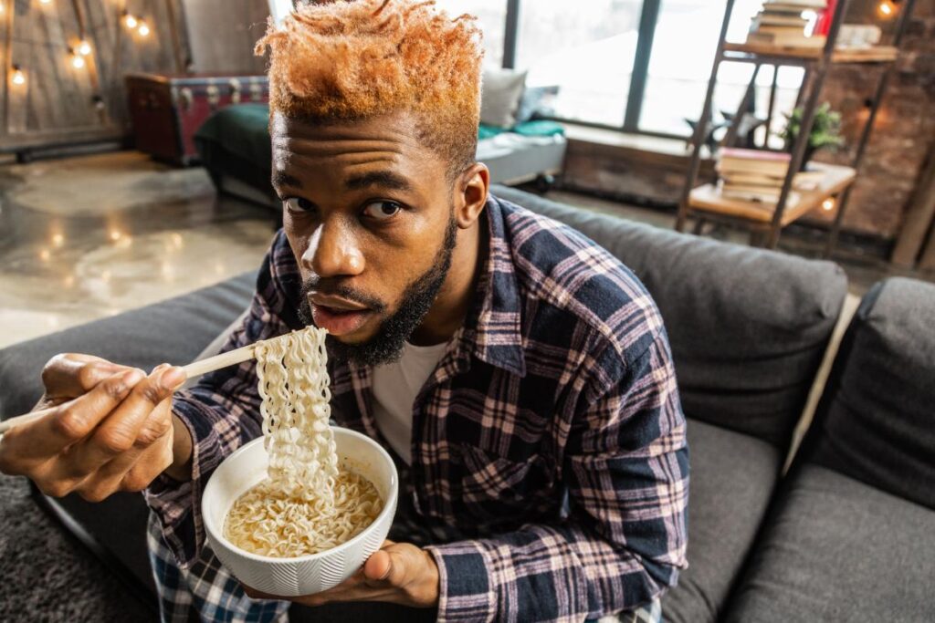 person eating bowl of ramen after learning answers to the question does cbd make you hungry