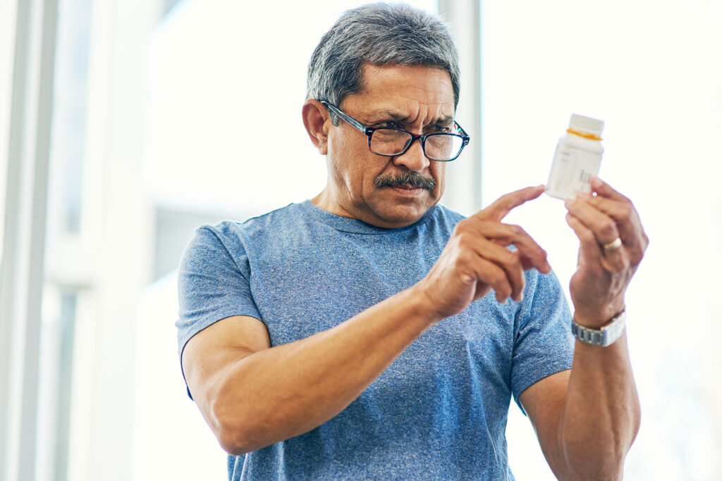 man looking at pill bottle wondering is vyvanse addictive