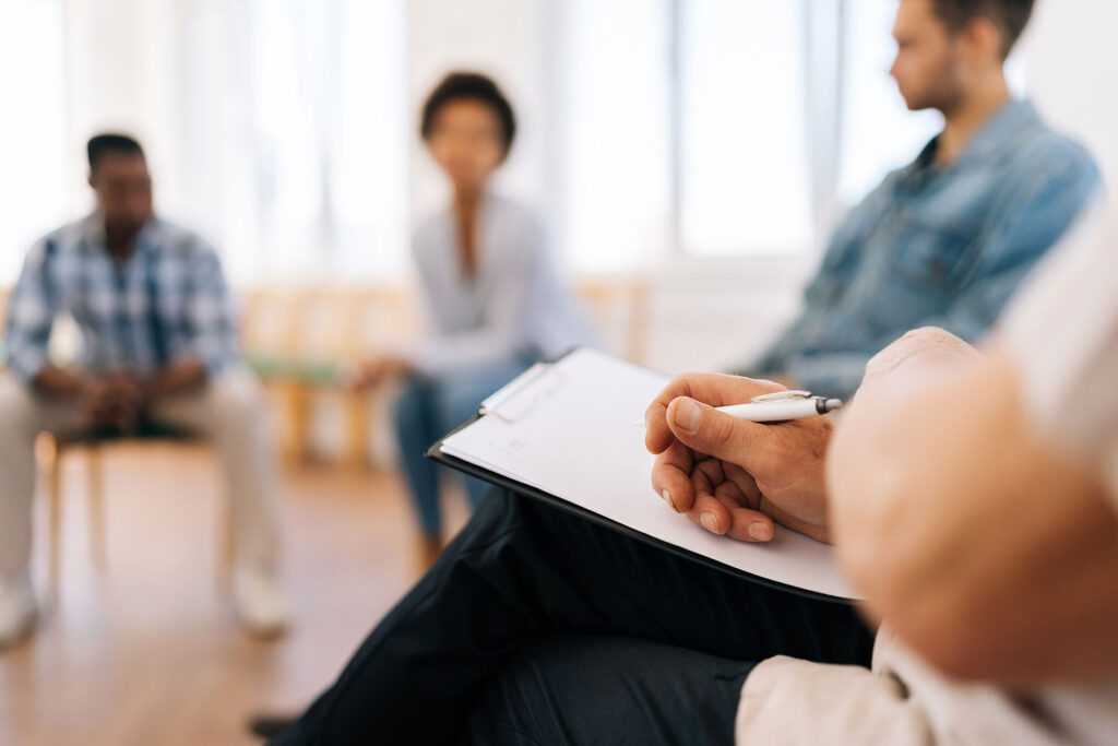 people in group therapy discussing what is a drug and alcohol assessment