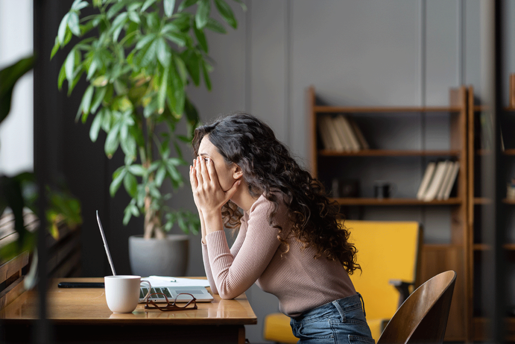 person with hans on face struggling while trying to work from home and looking for answers to what is high functioning anxiety