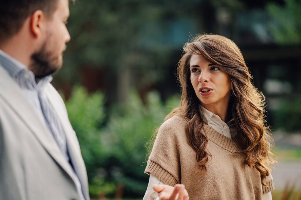 couple walking outdoors after learning answers to the question do narcissists attract people with bpd