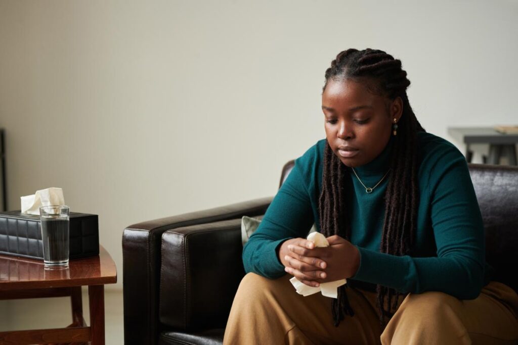 person sitting on therapists couch while seeking control over alcohol dependence and mental health