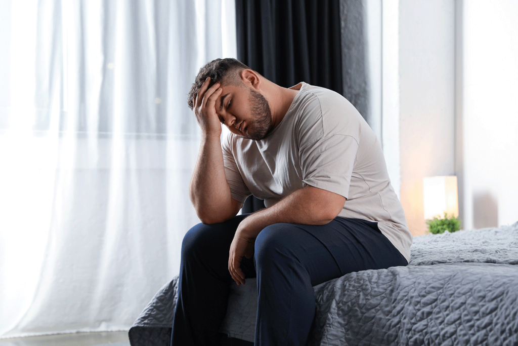 person with headache as one of the negative effects of marijuana