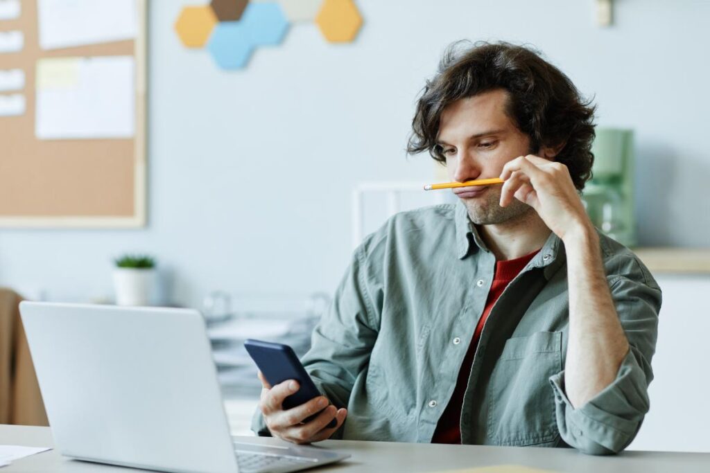 person in office using phone to read about myths about adhd